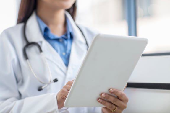 female-doctor-using-digital-tablet-mid-section-2022-03-08-00-15-32-utc